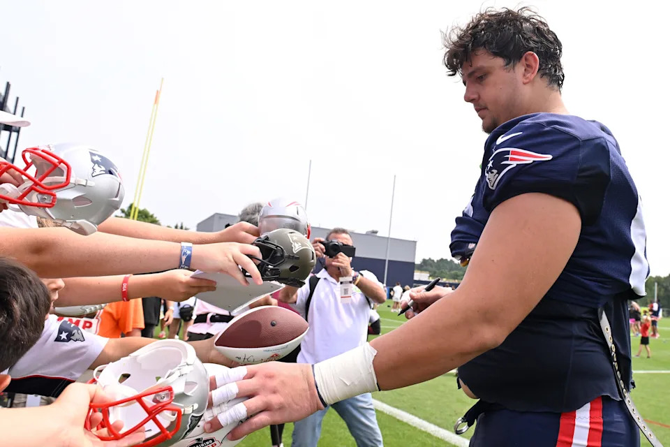 Aug 6, 2025; Foxborough, MA, USA; New England Patriots offensive tackle Will Campbell (66) signs autographs after training camp at Gillette Stadium. Mandatory Credit: Eric Canha-Imagn Images
