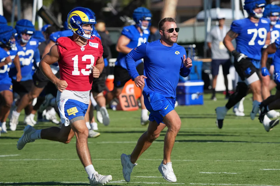 Los Angeles Rams coach Sean McVay runs with quarterback Stetson Bennett