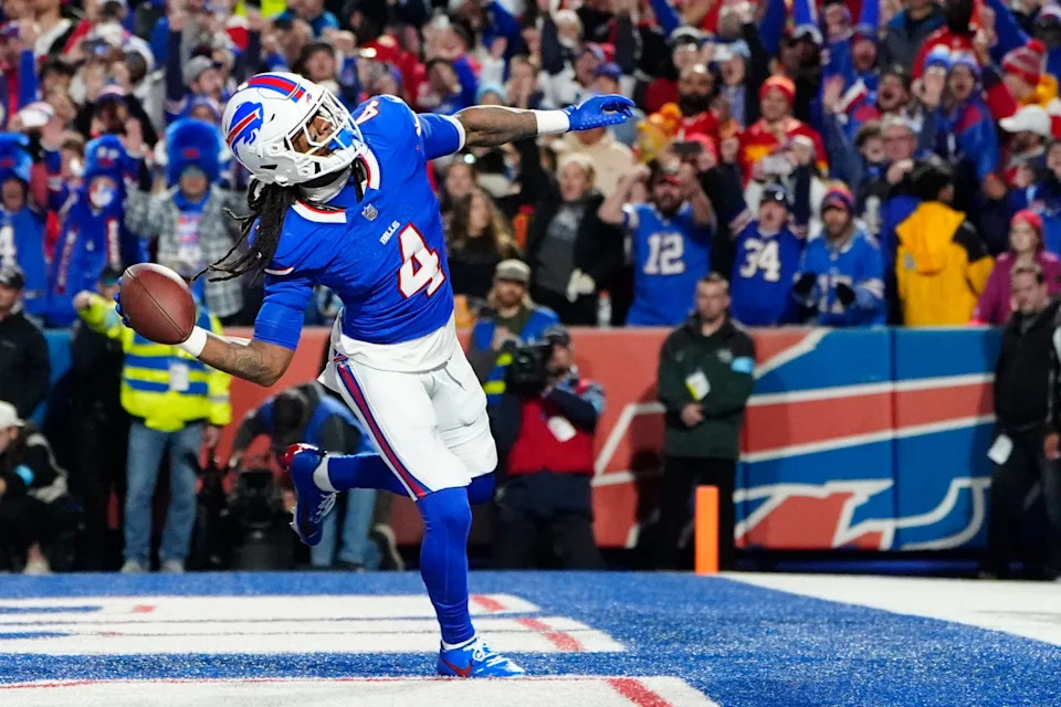 Nov 17, 2024; Orchard Park, New York, USA; Buffalo Bills running back James Cook (4) throws the ball into the stands to celebrate scoring a touchdown against the Kansas City Chiefs during the first half at Highmark Stadium. Mandatory Credit: Gregory Fisher-Imagn Images