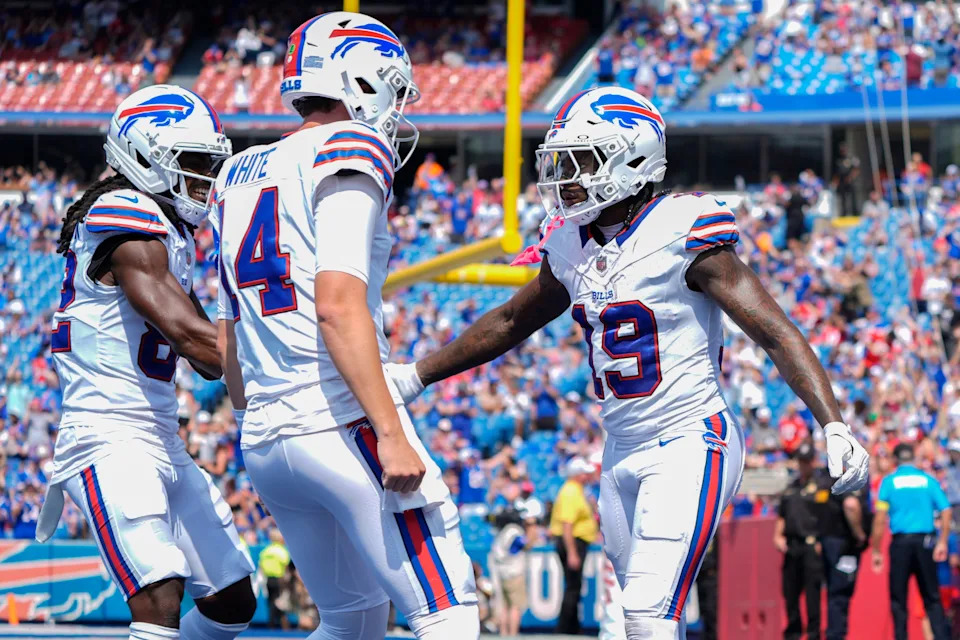 Aug 9, 2025; Orchard Park, New York, USA; Buffalo Bills wide receiver Kristian Wilkerson (82) and Buffalo Bills quarterback Mike White (14) congratulate Buffalo Bills wide receiver KJ Hamler (19) for scoring a touchdown against the New York Giants during the second half at Highmark Stadium. Mandatory Credit: Gregory Fisher-Imagn Images