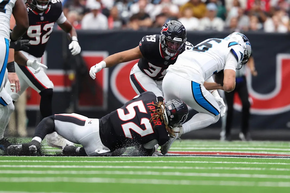 Aug 16, 2025; Houston, Texas, USA; Carolina Panthers quarterback Jack Plummer (16) is sacked by Houston Texans defensive end Darrell Taylor (52) and linebacker Henry To'oTo'o (39) during the second quarter at NRG Stadium. Mandatory Credit: Troy Taormina-Imagn Images