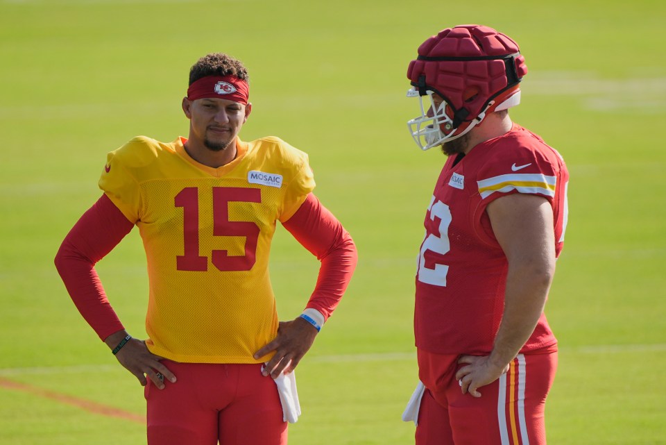 Patrick Mahomes and Creed Humphrey of the Kansas City Chiefs talking on the field.