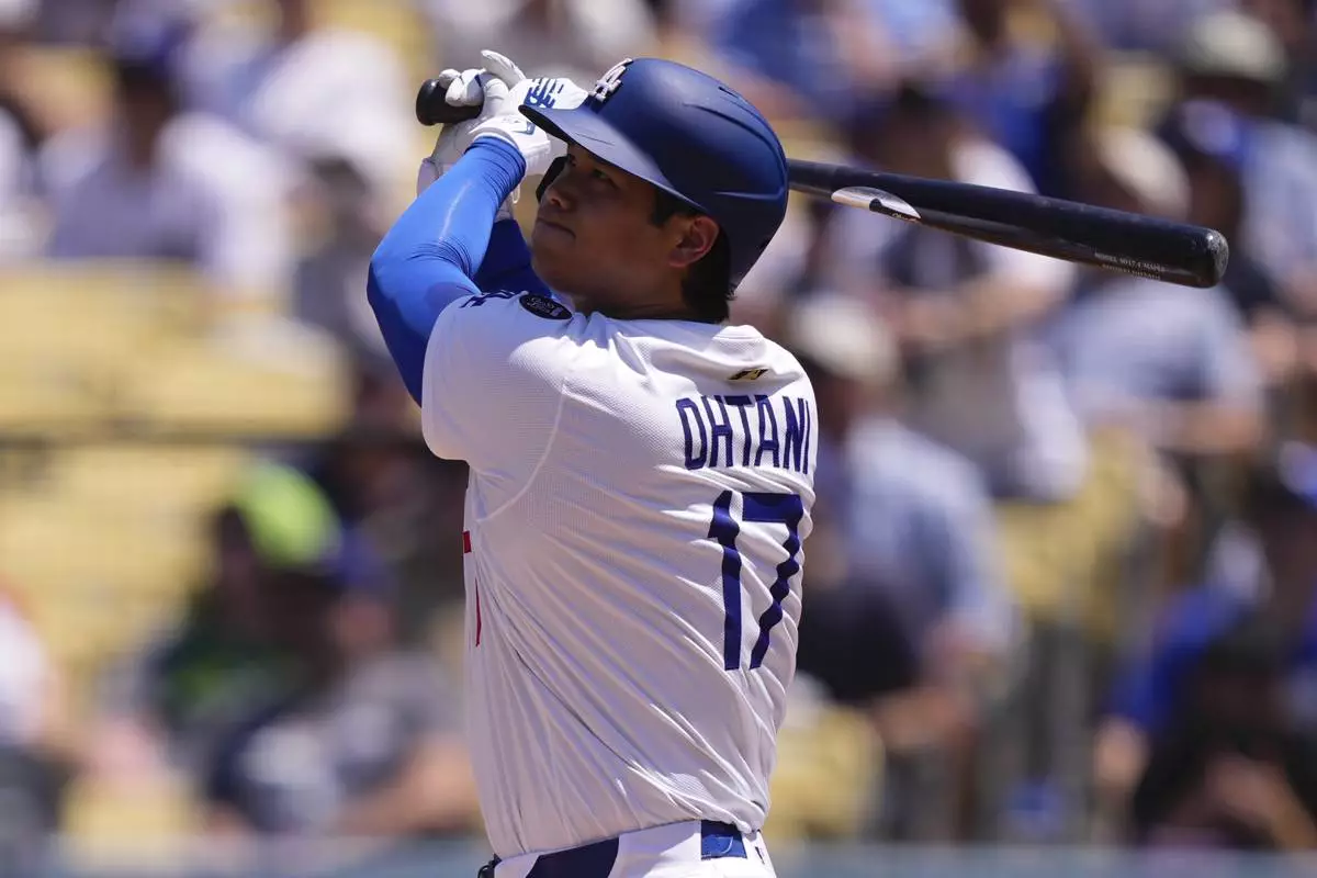 Los Angeles Dodgers' Shohei Ohtani hits a two-run home run and his 1,000th hit during the third inning of a baseball game Wednesday, Aug. 6, 2025, in Los Angeles. (AP Photo/Mark J. Terrill)