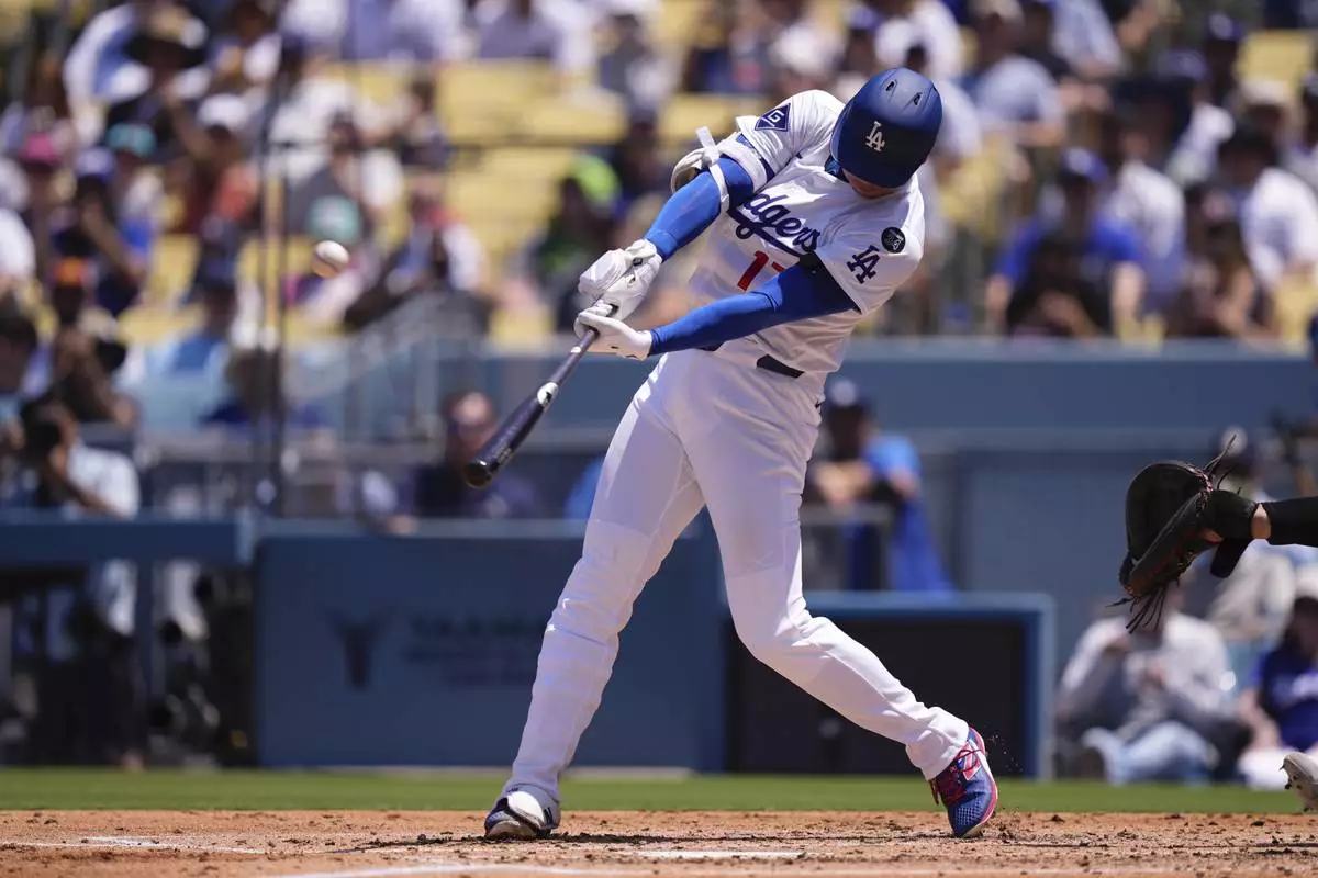 Los Angeles Dodgers' Shohei Ohtani hits a two-run home run and his 1,000th hit during the third inning of a baseball game Wednesday, Aug. 6, 2025, in Los Angeles. (AP Photo/Mark J. Terrill)