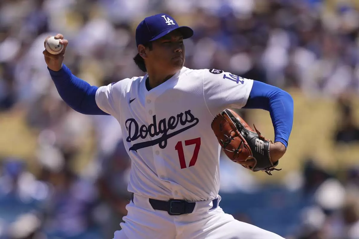 Los Angeles Dodgers starting pitcher Shohei Ohtani throws to the plate during the first inning of a baseball game against the St. Louis Cardinals, Wednesday, Aug. 6, 2025, in Los Angeles. (AP Photo/Mark J. Terrill)