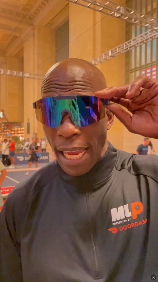 Chad Johnson wearing rainbow sunglasses and a DoorDash MLP jacket.