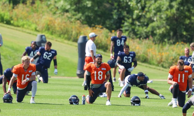 Bears quarterbacks Austin Reed (16), Caleb Williams (18) and Case Keenum (11) stretch during a joint practice with the Dolphins at Halas Hall on Aug. 8, 2025, in Lake Forest. (Stacey Wescott/Chicago Tribune)