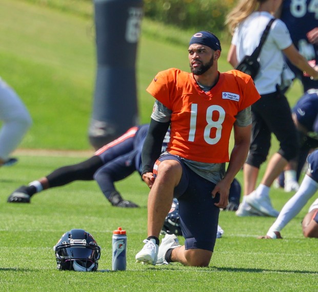 Bears quarterback Caleb Williams stretches during a joint practice with the Dolphins at Halas Hall on Aug. 8, 2025, in Lake Forest. (Stacey Wescott/Chicago Tribune)