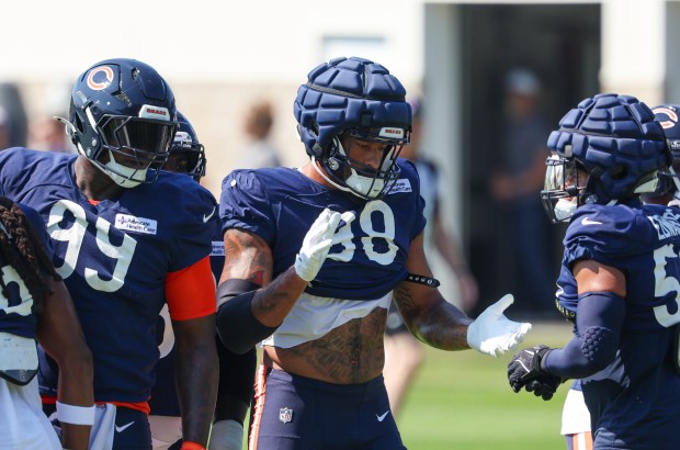 Bears defensive tackle Gervon Dexter Sr. (99), defensive end Montez Sweat (98) and linebacker T.J. Edwards huddle during a joint practice with the Dolphins at Halas Hall on Aug. 8, 2025, in Lake Forest. (Stacey Wescott/Chicago Tribune)