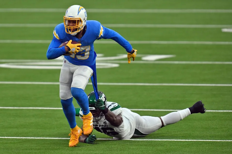 New York Jets linebacker Neville Hewitt, bottom, pulls on the jersey of Los Angeles Chargers wide receiver Keenan Allen after a catch by Allen during the second half of an NFL football game Sunday, Nov. 22, 2020, in Inglewood, Calif. AP