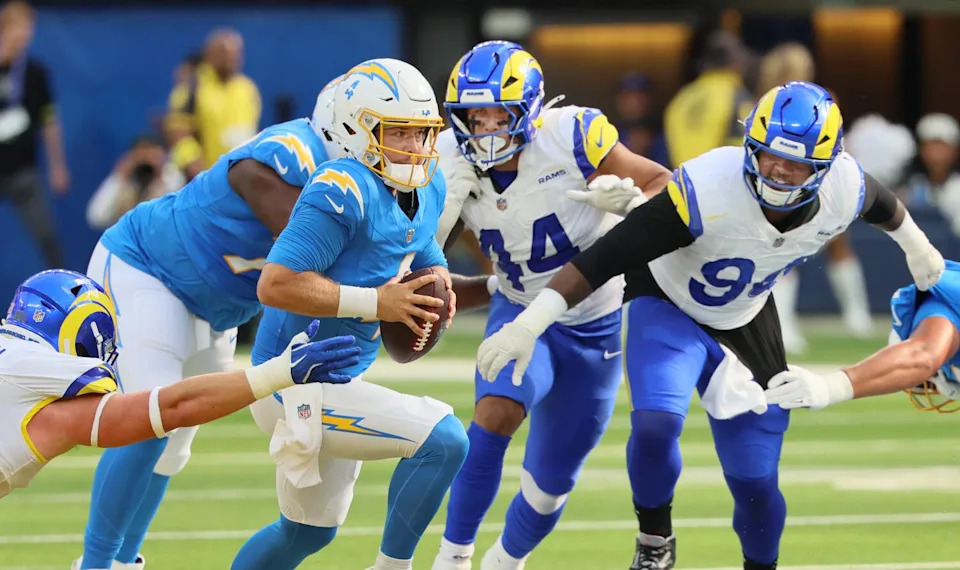 Chargers quarterback Taylor Heinicke tries to escape the Rams defense during a preseason loss on Aug. 16.