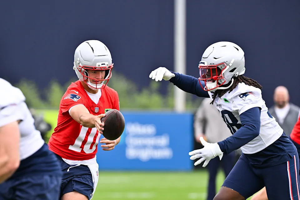 Jun 9, 2025; Foxborough, MA, USA; New England Patriots quarterback Drake Maye (10) hands the ball to running back Rhamondre Stevenson (38) during minicamp at Gillette Stadium. Mandatory Credit: Eric Canha-Imagn Images