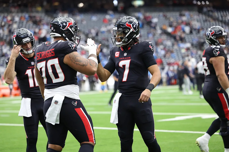 Jan 11, 2025; Houston, Texas, USA; Houston Texans guard Juice Scruggs (70) and quarterback C.J. Stroud (7) warm up prior to the game against the Los Angeles Chargers in an AFC wild card game at NRG Stadium. Mandatory Credit: Troy Taormina-Imagn Images