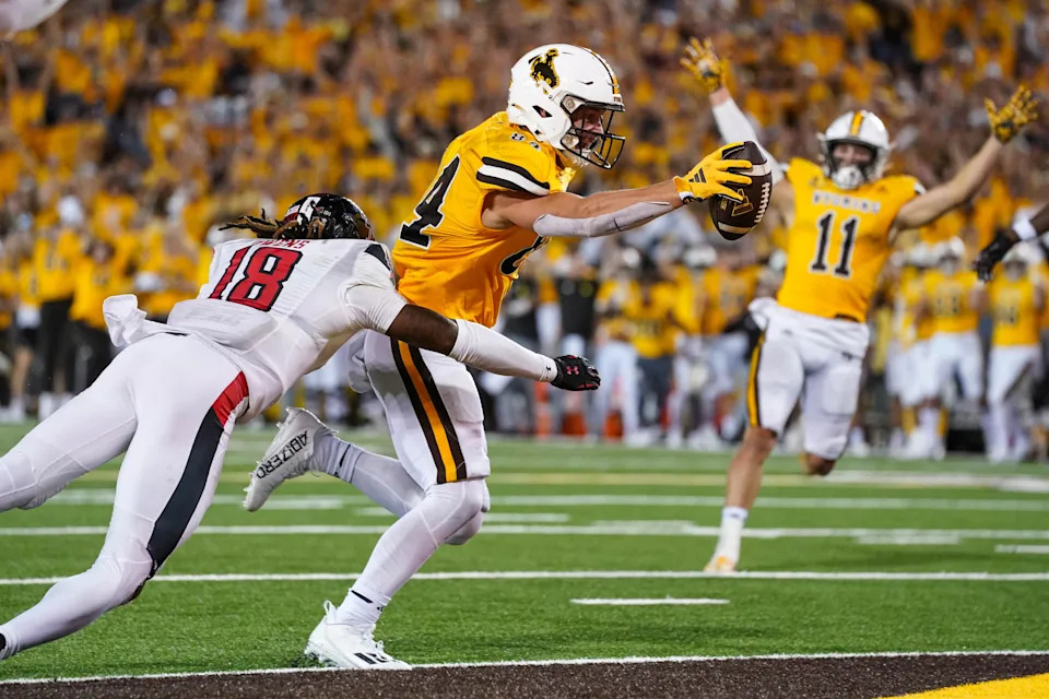 Sep 2, 2023; Laramie, Wyoming, USA; Wyoming Cowboys tight end John Michael Gyllenborg (84) scores a touchdown in double overtime against the Texas Tech Red Raiders at Jonah Field at War Memorial Stadium. Mandatory Credit: Troy Babbitt-USA TODAY Sports