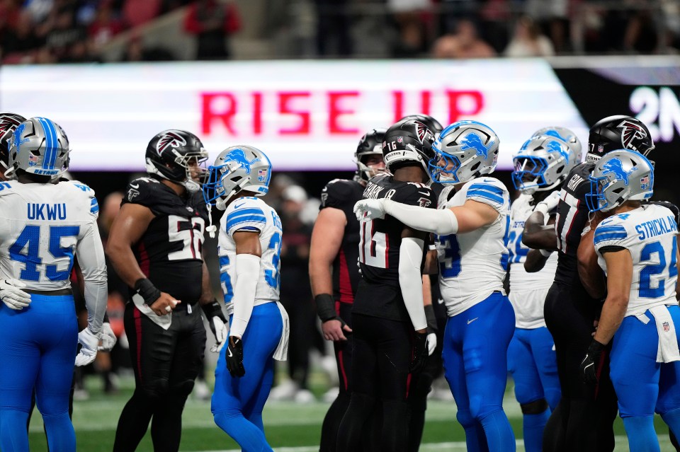 Detroit Lions and Atlanta Falcons players embracing on the field.
