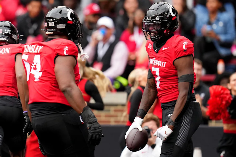 Cincinnati Bearcats tight end Chamon Metayer (7) celebrates a touchdown catch with Cincinnati Bearcats offensive lineman Dartanyan Tinsley (54) in the first quarter during a college football game between the Iowa State Cyclones and the Cincinnati Bearcats Saturday, Oct. 14, 2023, at Nippert Stadium win Cincinnati.
