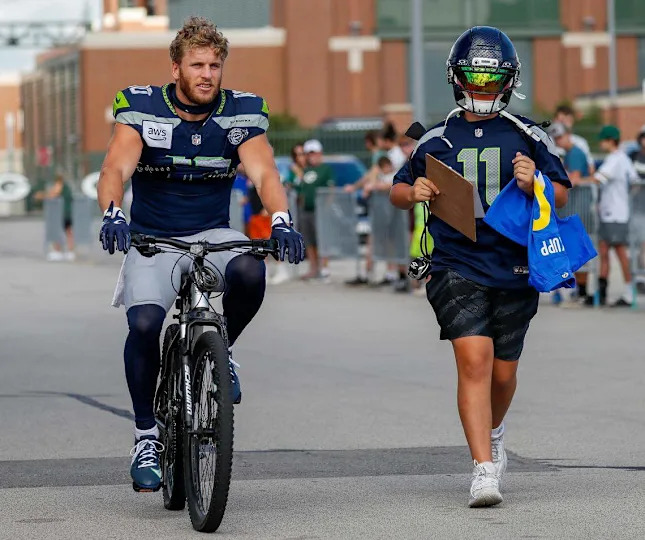 Seattle Seahawks wide receiver Cooper Kupp (10) rides a bicycle to a joint practice with the Green Bay Packers on Thursday, August 21, 2025, at Lambeau Field in Green Bay, Wis. Tork Mason/USA TODAY NETWORK-Wisconsin Tork Mason/USA TODAY NETWORK