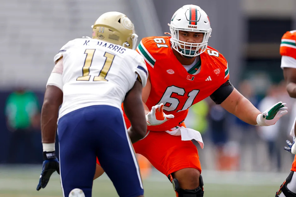 ATLANTA, GEORGIA - NOVEMBER 9: Francis Mauigoa #61 of the Miami Hurricanes looks to block Kevin Harris II #11 of the Georgia Tech Yellow Jackets during the first quarter at Bobby Dodd Stadium on November 9, 2024 in Atlanta, Georgia. (Photo by Todd Kirkland/Getty Images)
