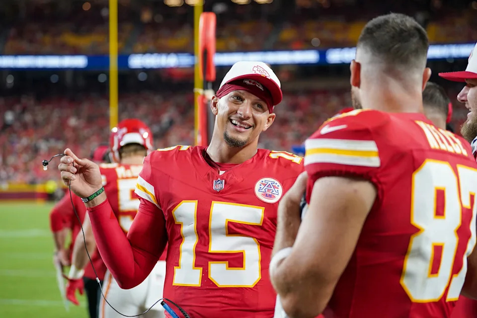 Aug 22, 2025; Kansas City, Missouri, USA; Kansas City Chiefs quarterback Patrick Mahomes (15) talks with tight end Travis Kelce (87) on the sidelines against the Chicago Bears during the first half of the game at GEHA Field at Arrowhead Stadium. Mandatory Credit: Denny Medley-Imagn Images