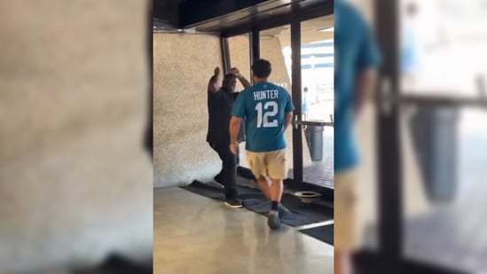 In the video, a Jaguars fan in a Travis Hunter jersey can be seen fighting the Saints fan, who is in a black tee-shirt.(X/@NFL_DovKleiman)