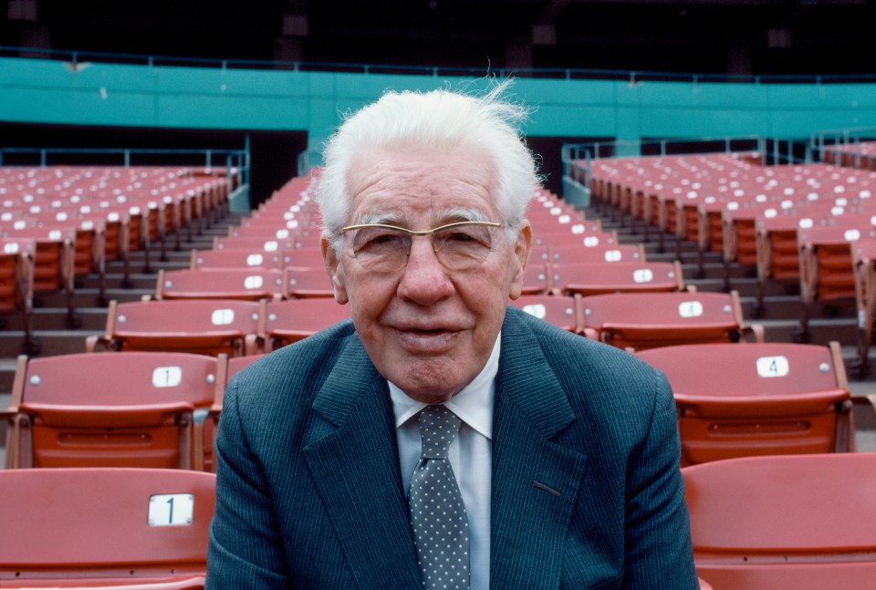 Art Rooney, founder and chairman of the Pittsburgh Steelers, seated in stadium.