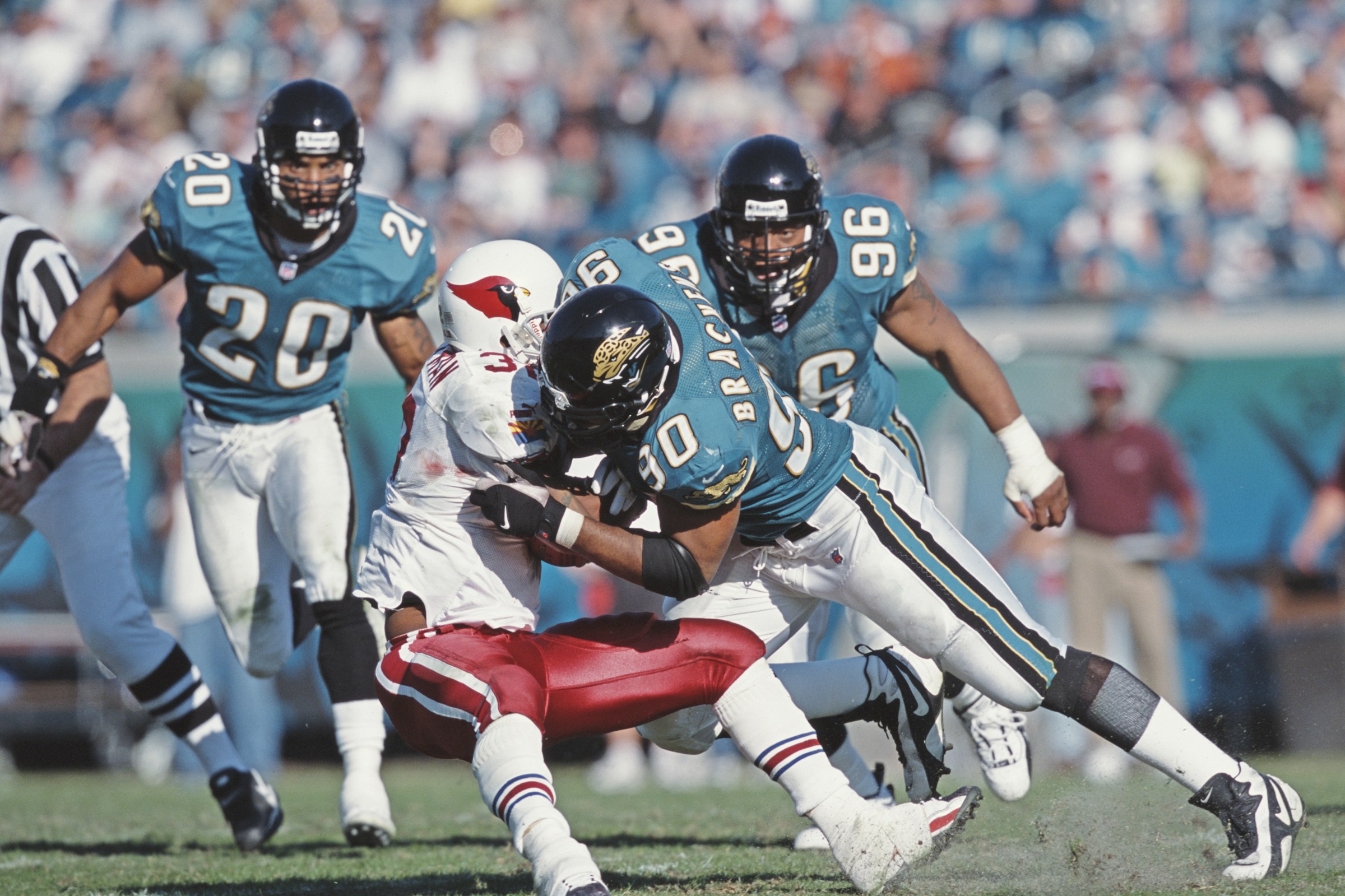 Tony Brackens #90, Defensive End for the Jacksonville Jaguars tackles Michael Pittman #32, Running Back of the Arizona Cardinals during their American Football Conference Central game on 10th December 2000 at the Alltel Stadium, Jacksonville, Florida, United States. The Jaguars won the game 44 - 10. (Photo by Craig Jones/Getty Images)