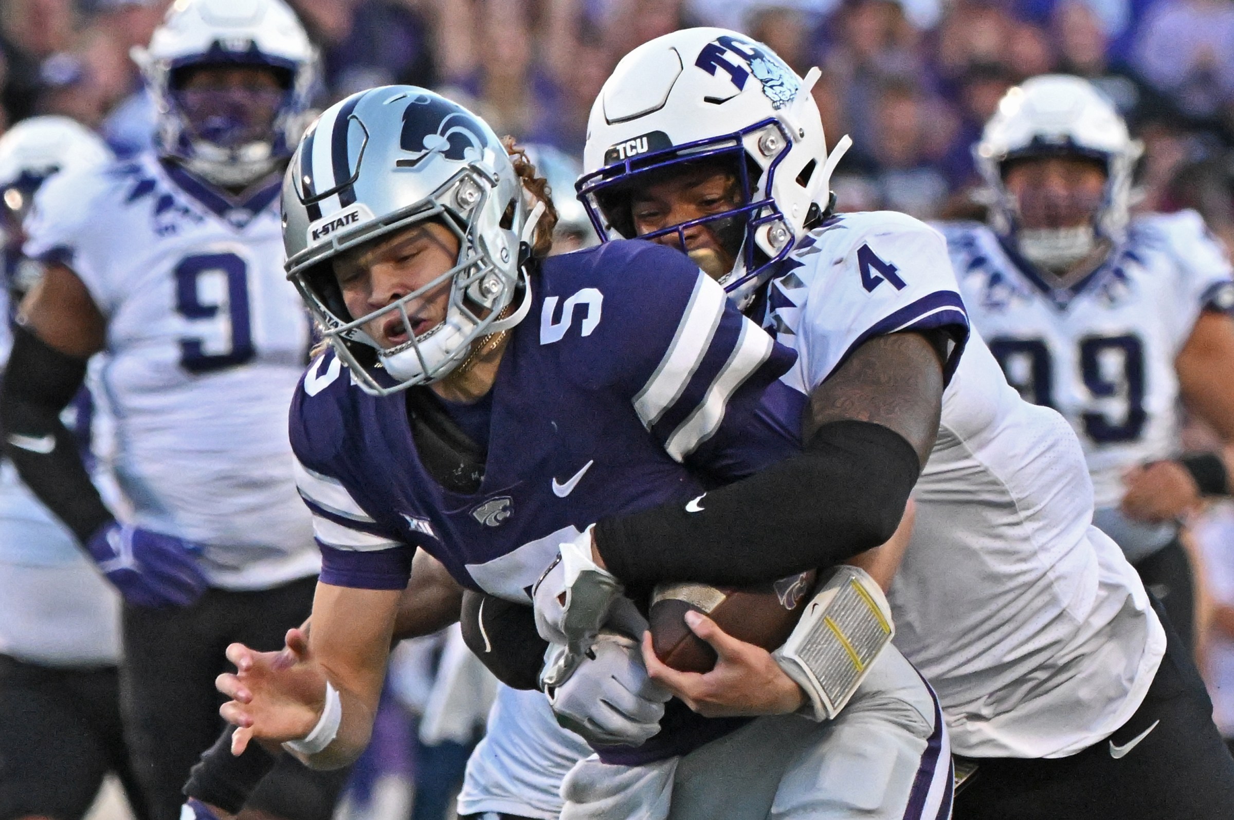 MANHATTAN, KS - OCTOBER 21: Linebacker Namdi Obiazor #4 of the TCU Horned Frogs tackles quarterback Avery Johnson #5 of the Kansas State Wildcats during the first half at Bill Snyder Family Football Stadium on October 21, 2023 in Manhattan, Kansas. (Photo by Peter Aiken/Getty Images)