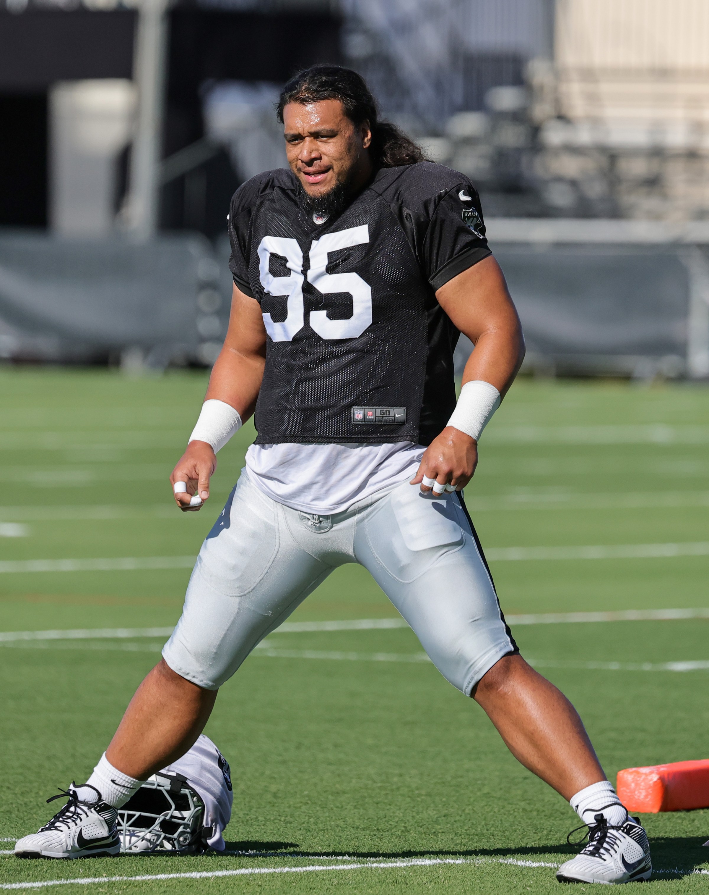 HENDERSON, NEVADA - JULY 31: Leki Fotu #95 of the Las Vegas Raiders stretches during the team’s training camp at the Las Vegas Raiders Headquarters/Intermountain Health Performance Center on July 31, 2025 in Henderson, Nevada. (Photo by Ethan Miller/Getty Images)