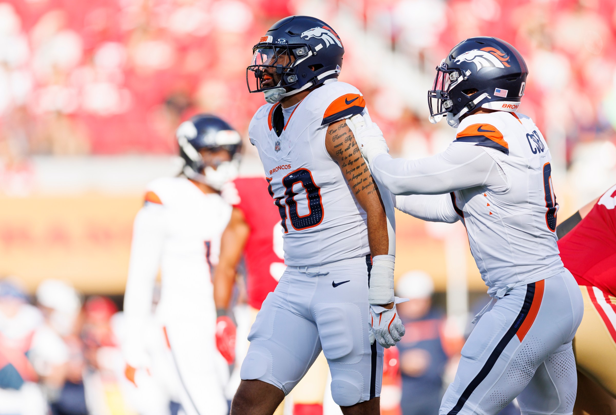SANTA CLARA, CA - AUGUST 9: Justin Strnad #40 of the Denver Broncos celebrates with Jonathon Cooper #0 after a tackle during the first half of an NFL preseason football game against the San Francisco 49ers, at Levi’s Stadium on August 9, 2025 in Santa Clara, California. (Photo by Brooke Sutton/Getty Images)
