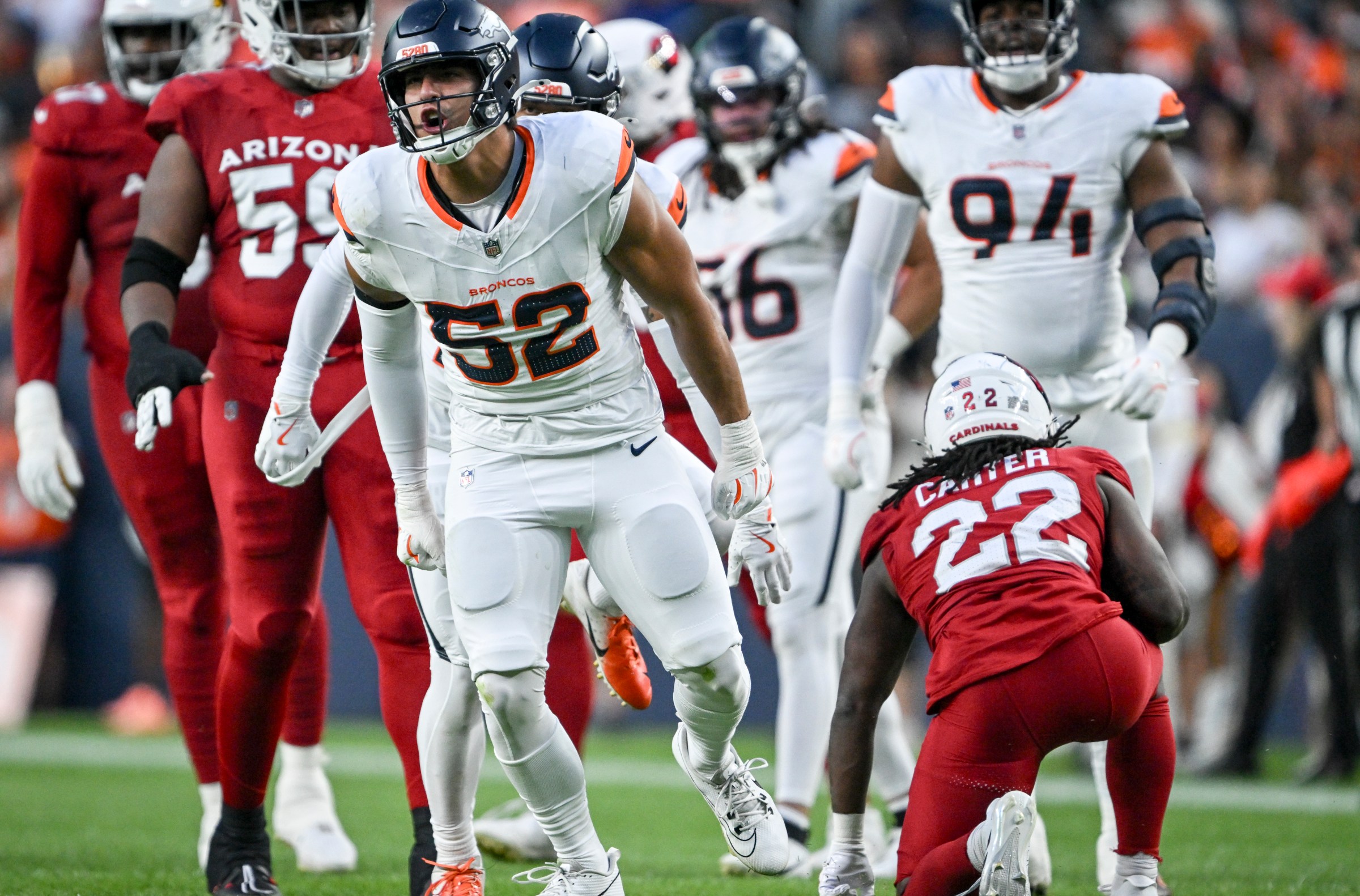 DENVER, CO - AUGUST 16: Jonah Elliss (52) of the Denver Broncos celebrates tackling Michael Carter (22) of the Arizona Cardinals during the first quarter at Empower Field at Mile High in Denver, Colorado on Saturday, August 16, 2025. (Photo by AAron Ontiveroz/The Denver Post)