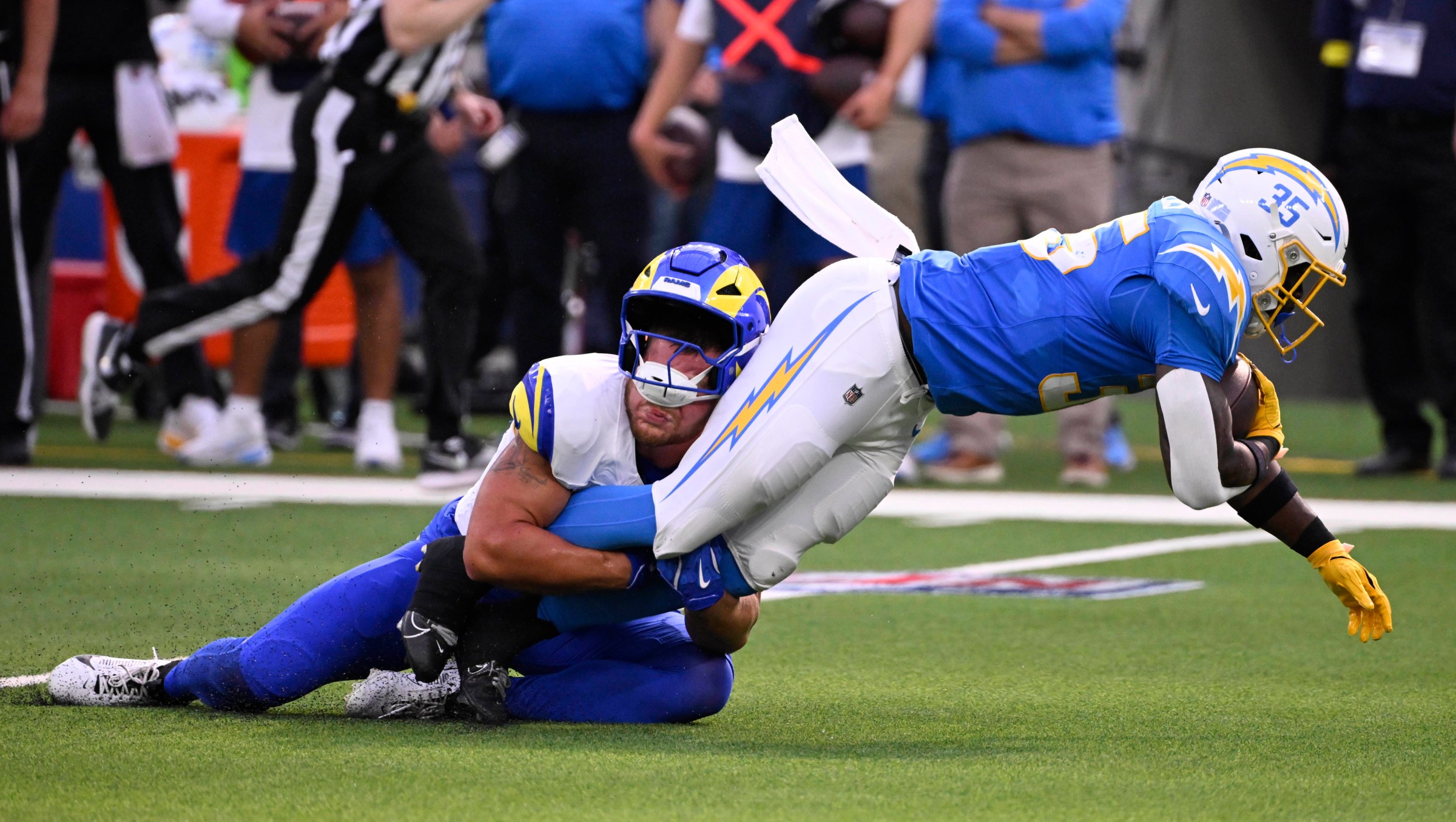 Inglewood, CA - August 16: Running back Raheim Sanders #35 of the Los Angeles Chargers is tackled by linebacker Shaun Dolac #56 of the Los Angeles Rams in the first half of a preseason NFL football game at SoFi Stadium in Inglewood on Saturday, August 16, 2025. (Photo by Keith Birmingham/MediaNews Group/Pasadena Star-News via Getty Images)