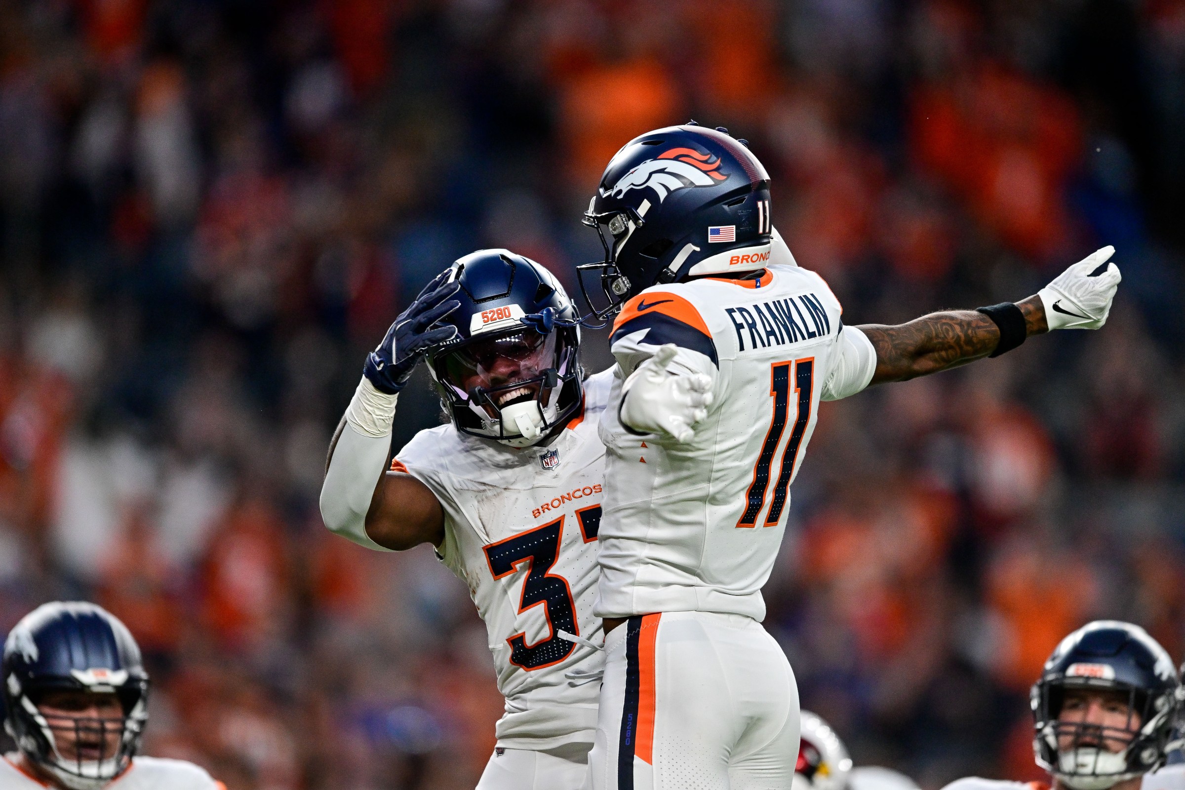 DENVER, CO - AUGUST 16: Denver Broncos running back RJ Harvey (37) celebrates with wide receiver Troy Franklin (11) after his first quarter touchdown during a preseason game between the Arizona Cardinals and the Denver Broncos at Empower Field at Mile High on August 16, 2025 in Denver, Colorado. (Photo by Dustin Bradford/Icon Sportswire via Getty Images)