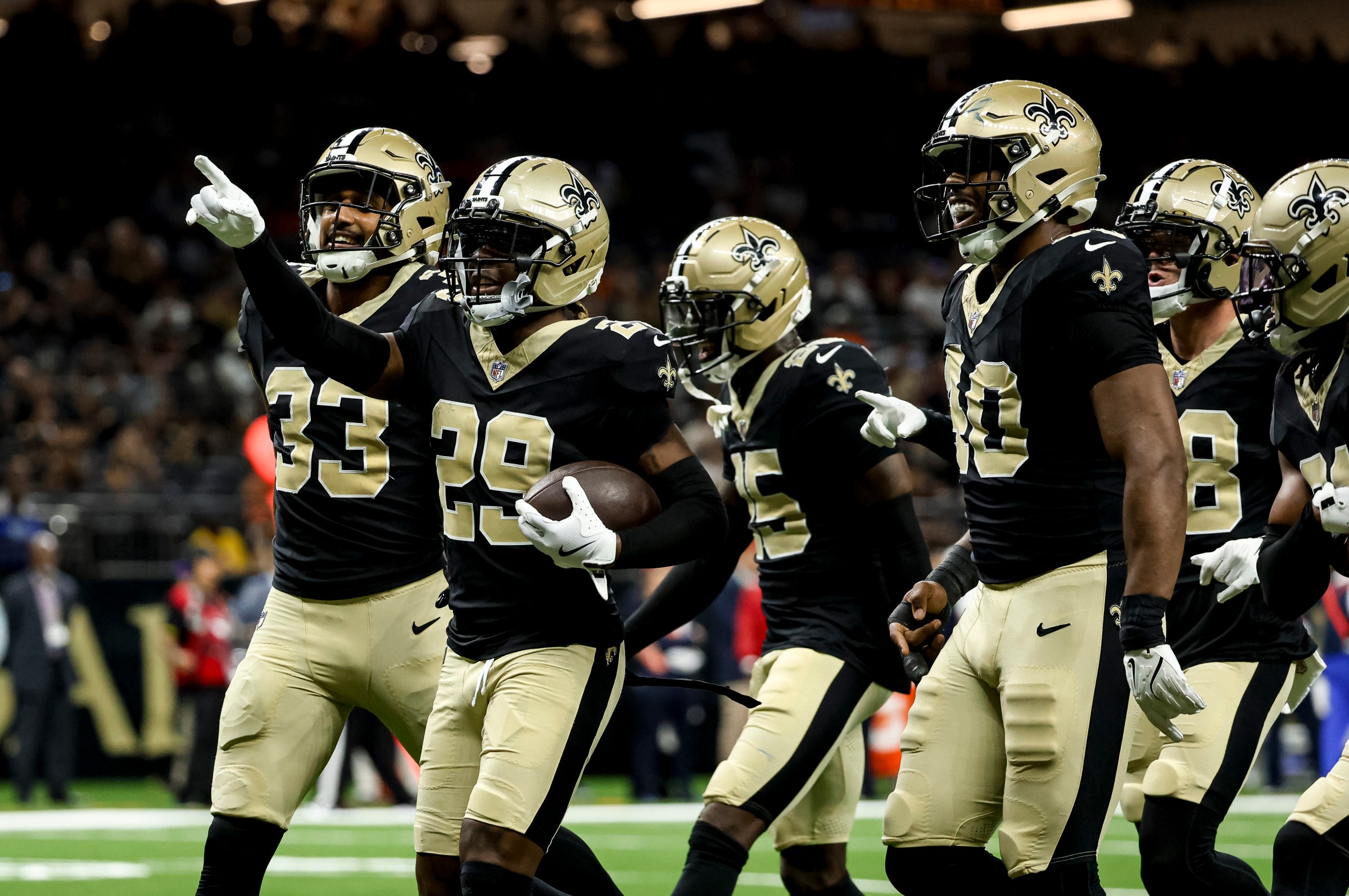 NEW ORLEANS, LOUISIANA - AUGUST 23: Quincy Riley #29 of the New Orleans Saints celebrates with teammates after an interception against the Denver Broncos during the second half of an NFL Preseason 2025 game at the Caesars Superdome on August 23, 2025 in New Orleans, Louisiana. (Photo by Derick E. Hingle/Getty Images)