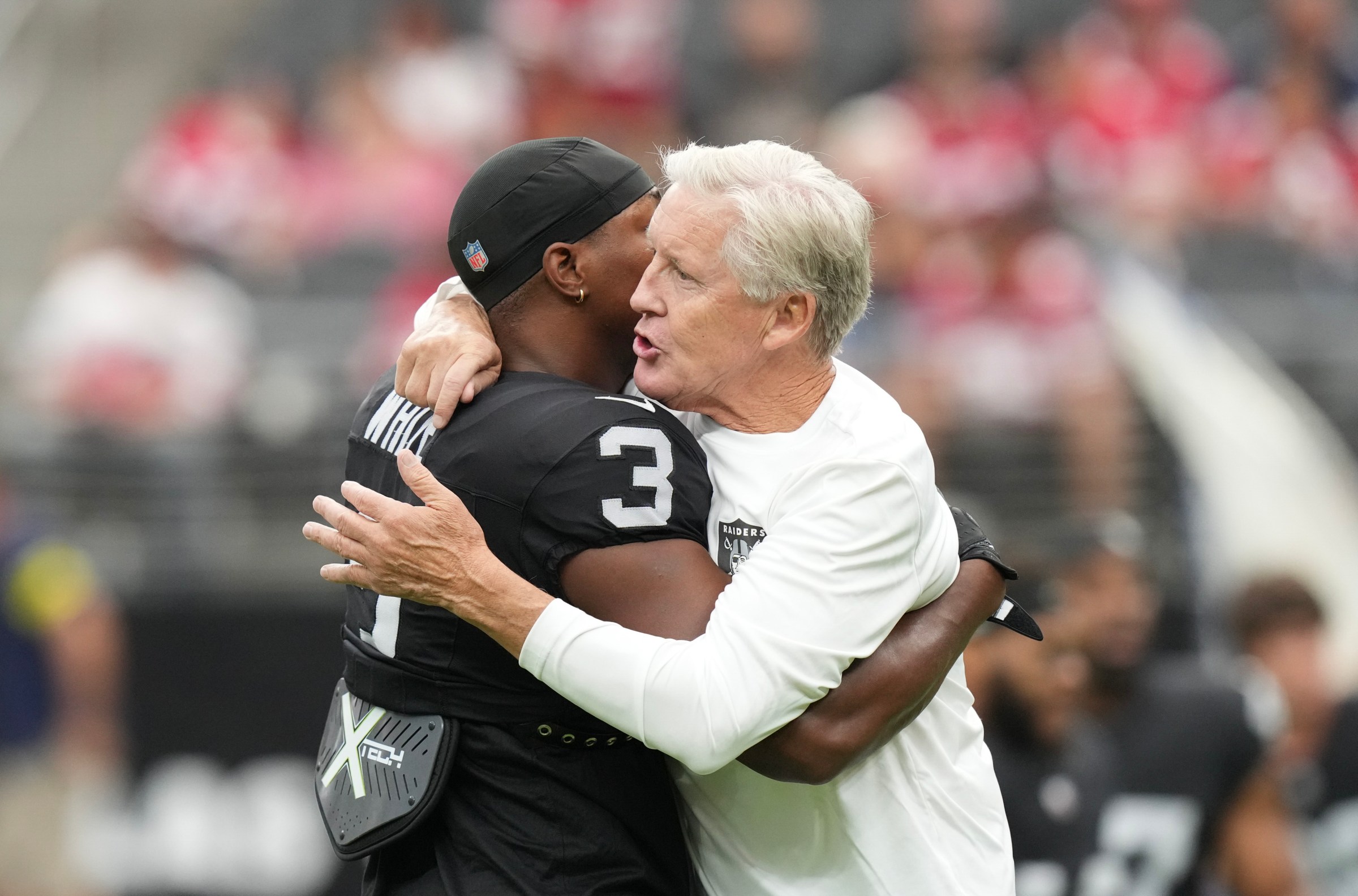 LAS VEGAS, NEVADA - AUGUST 16: Zamir White #3 of the Las Vegas Raiders hugs head coach Pete Carroll during warm up against the San Francisco 49ers during the NFL Preseason 2025 game at Allegiant Stadium on August 16, 2025 in Las Vegas, Nevada. The 49ers defeated the Raiders 22-19. (Photo by Candice Ward/Getty Images)