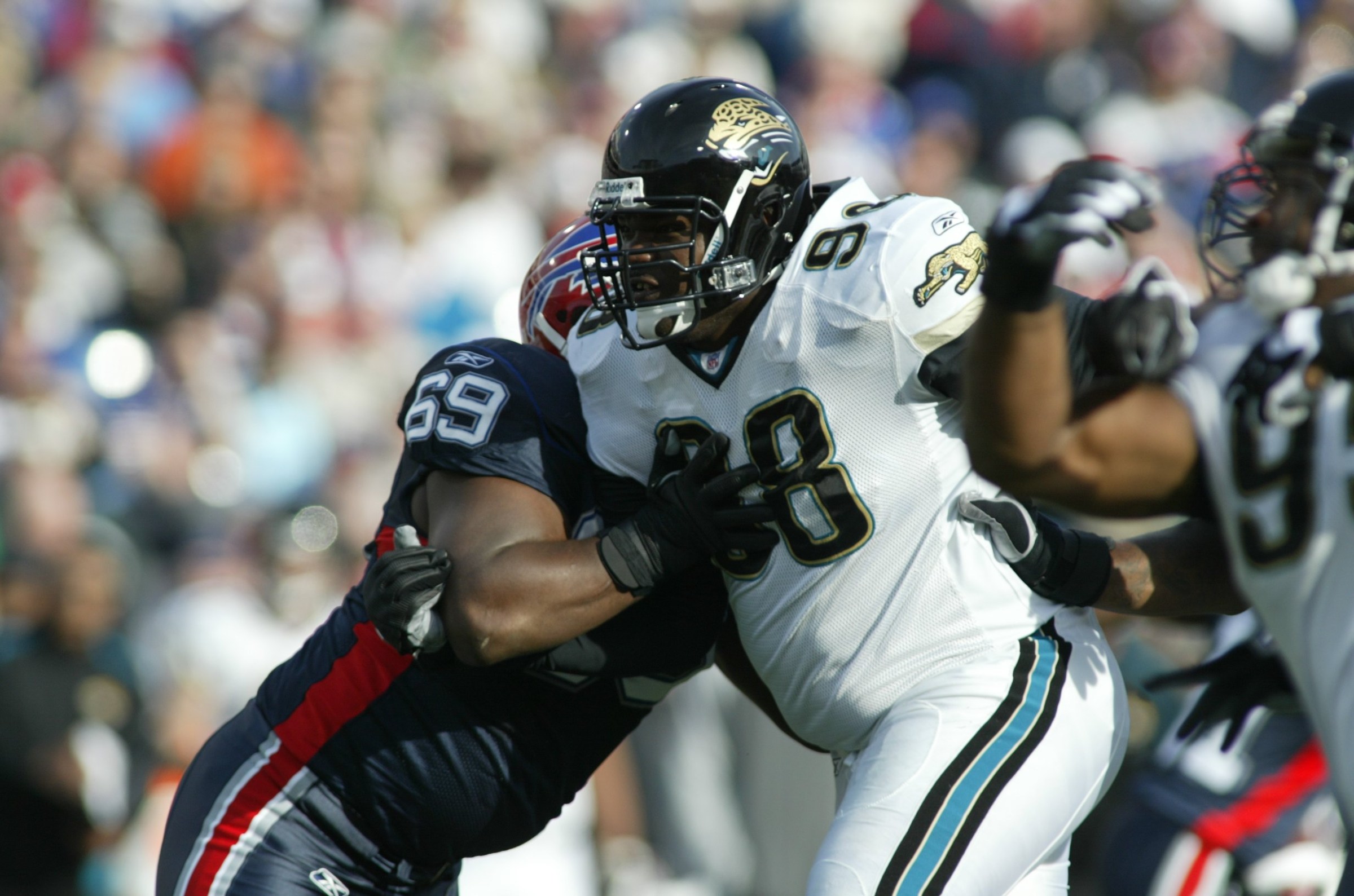 ORCHARD PARK, NY - NOVEMBER 26: Defensive tackle John Henderson #98 of the Jacksonville Jaguars rushes against offensive lineman Mike Gandy #69 of the Buffalo Bills on November 26, 2006 at Ralph Wilson Stadium in Orchard Park, New York. The Bills defeated the Jags 27-24. (Photo by Rick Stewart/Getty Images)