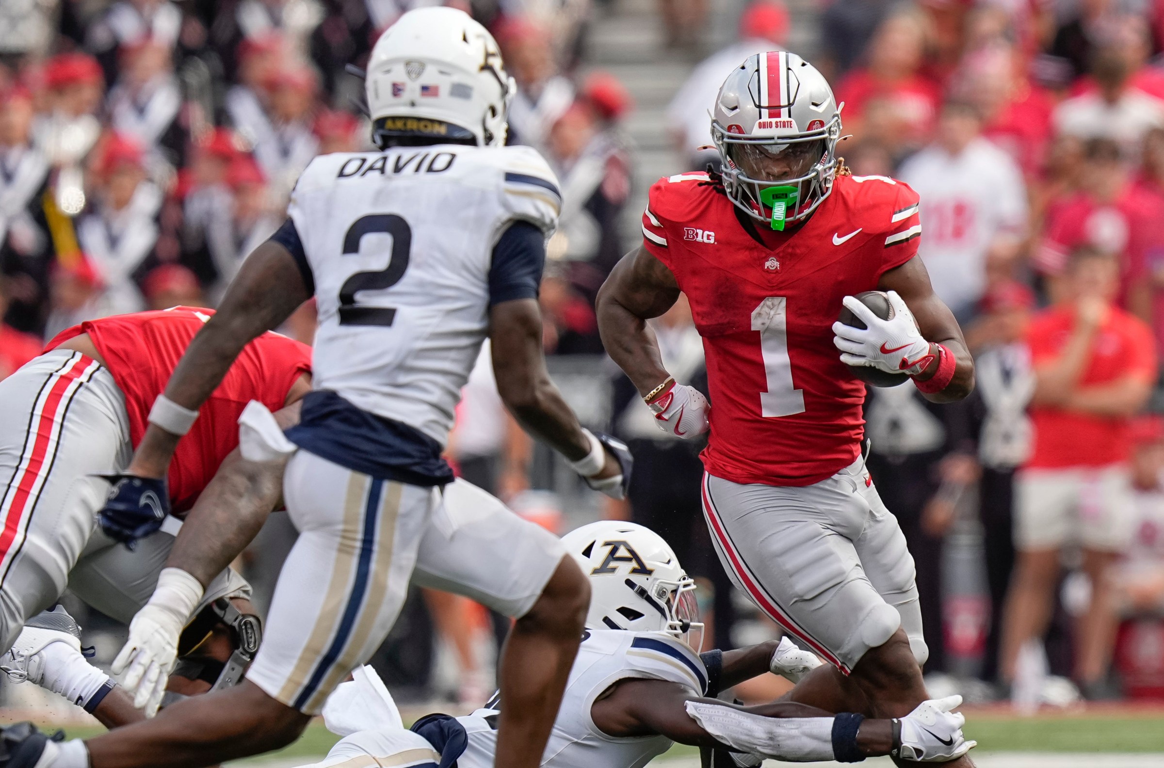 Aug 31, 2024; Columbus, OH, USA; Ohio State Buckeyes running back Quinshon Judkins (1) runs toward Akron Zips safety Daymon David (2) during the NCAA football game at Ohio Stadium. Ohio State won 52-6.