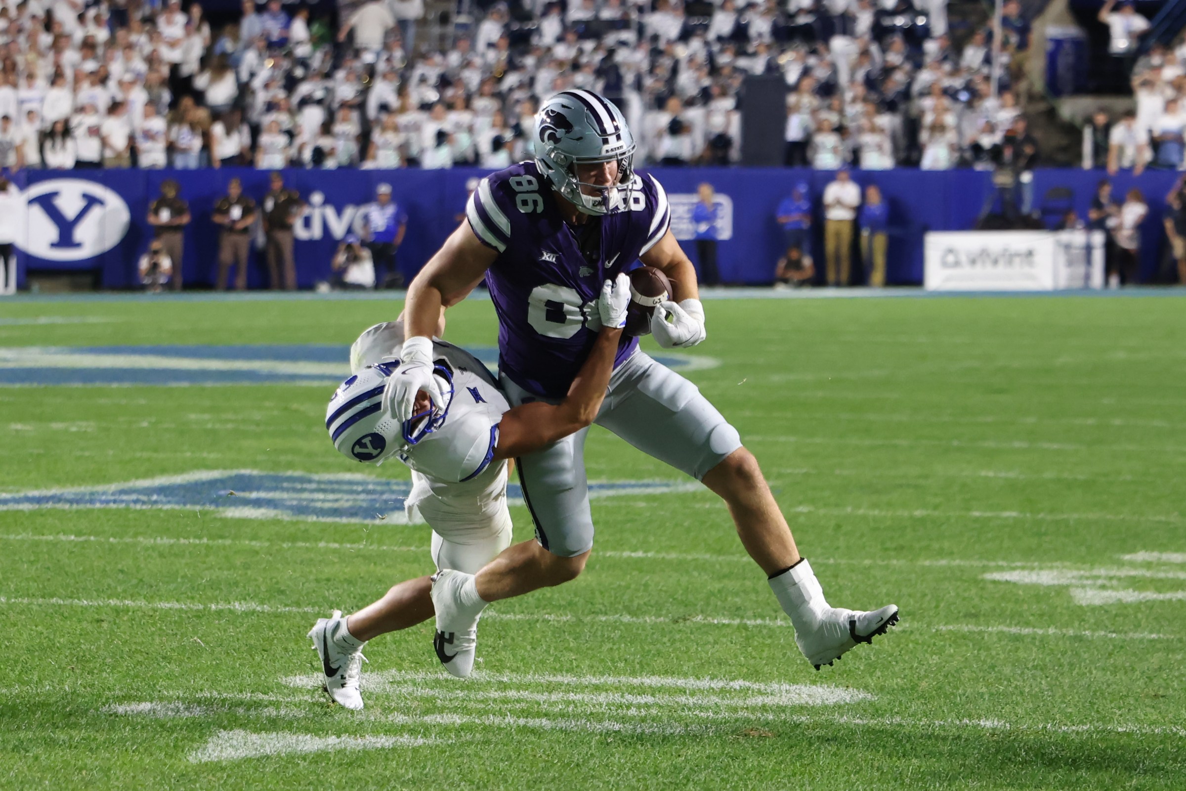 Sep 21, 2024; Provo, Utah, USA; Kansas State Wildcats tight end Garrett Oakley (86) runs the ball defended by Brigham Young Cougars safety Crew Wakley (7) during the third quarter at LaVell Edwards Stadium.