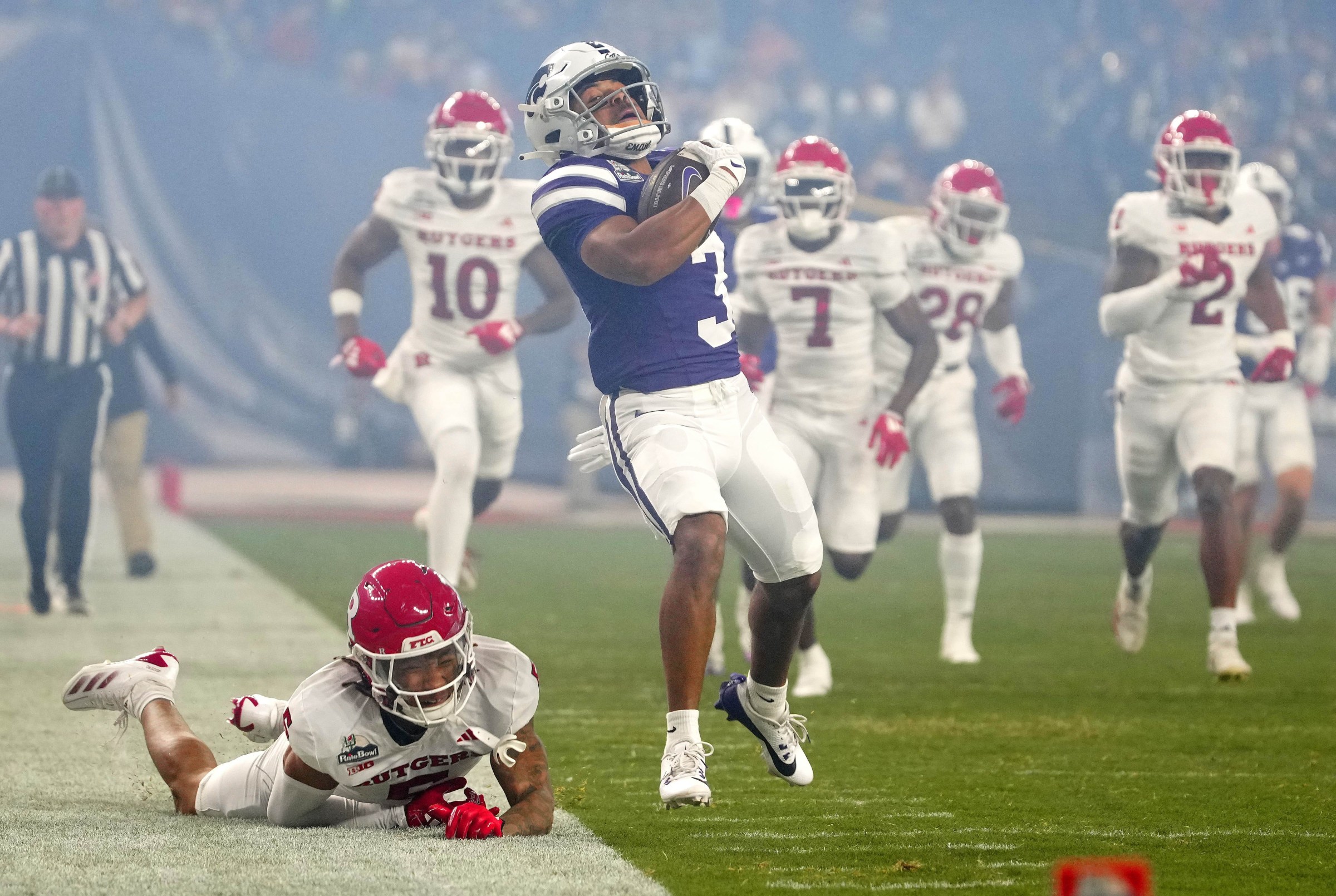 Kansas State runningback Dylan Edwards (3) breaks a tackle from Rutgers safety Kaj Sanders (5) during first half of the Rate Bowl at Chase Field on Dec. 26, 2024, Phoenix.