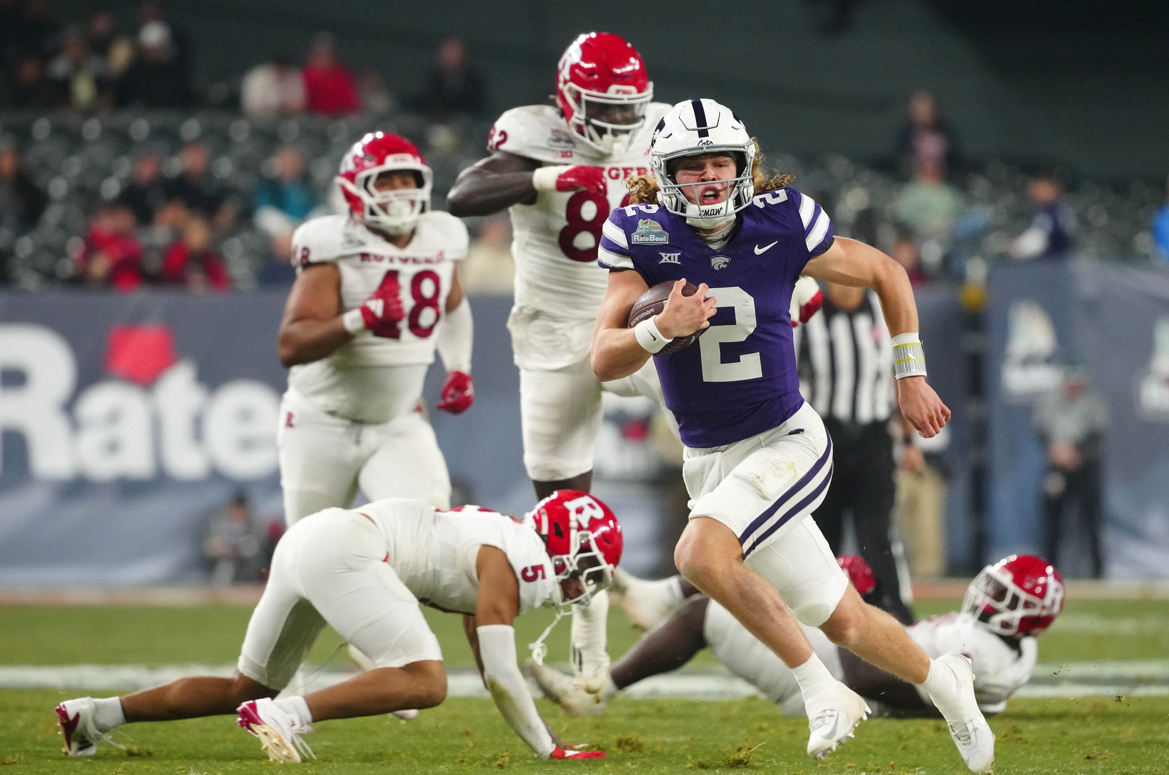 Kansas State quarterback Avery Johnson (2) scrambles against Rutgers during second half of the Rate Bowl at Chase Field on Dec. 26, 2024, in Phoenix.