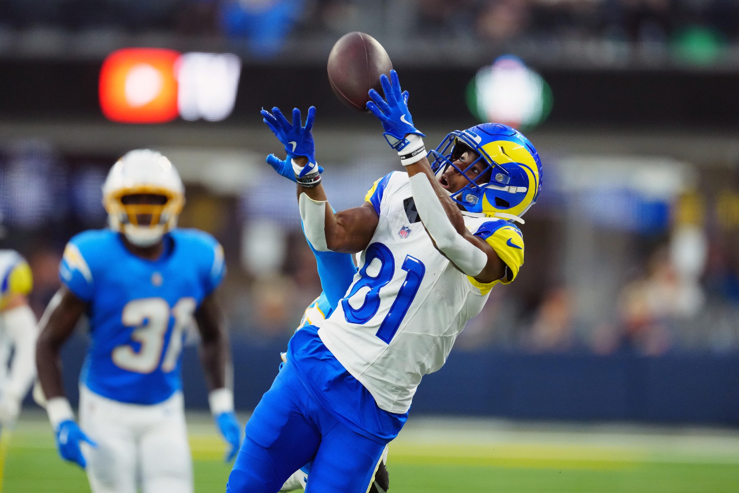 Aug 16, 2025; Inglewood, California, USA; iLos Angeles Rams wide receiver Brennan Presley (81) attempts to catch the ball against Los Angeles Chargers cornerback Nikko Reed (46) in the second half at SoFi Stadium. Mandatory Credit: Kirby Lee-Imagn Images
