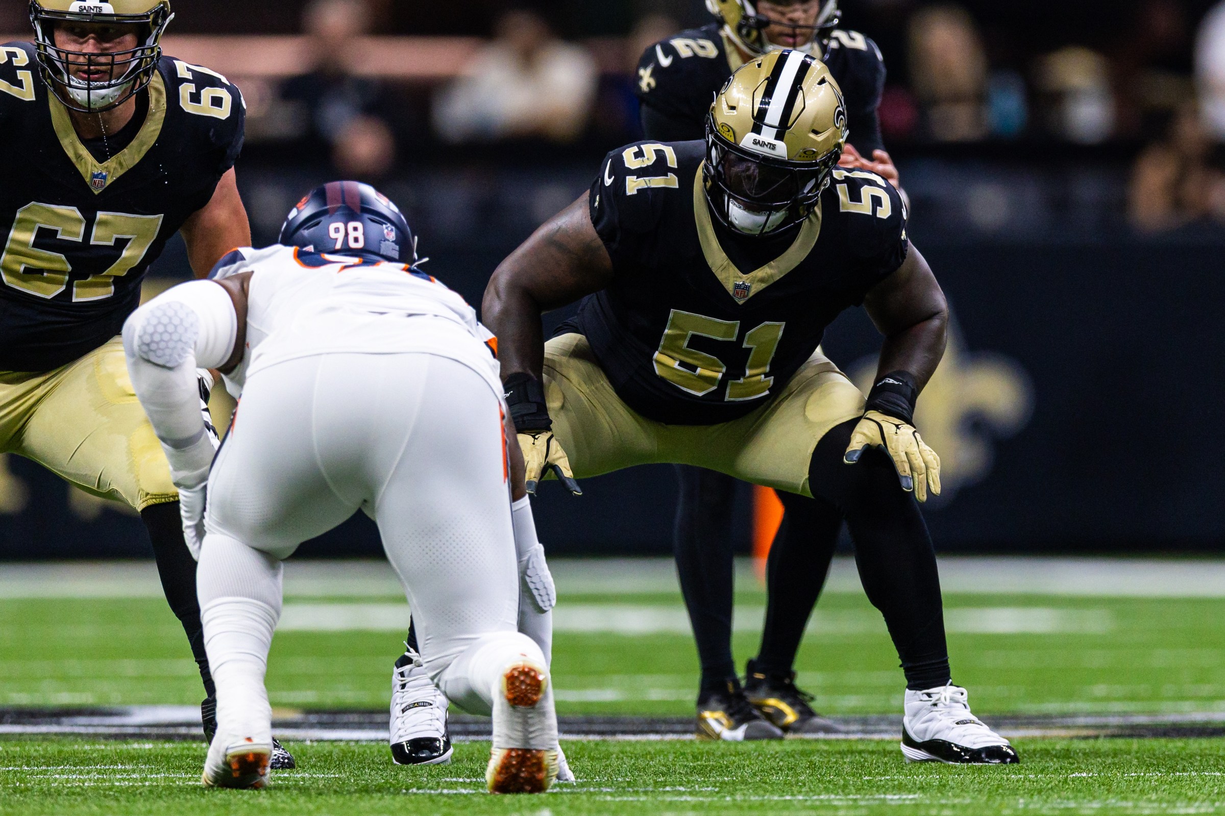 Aug 23, 2025; New Orleans, Louisiana, USA; New Orleans Saints center Cesar Ruiz (51) blocks Denver Broncos defensive end John Franklin-Myers (98) during the first half at Caesars Superdome. Mandatory Credit: Stephen Lew-Imagn Images