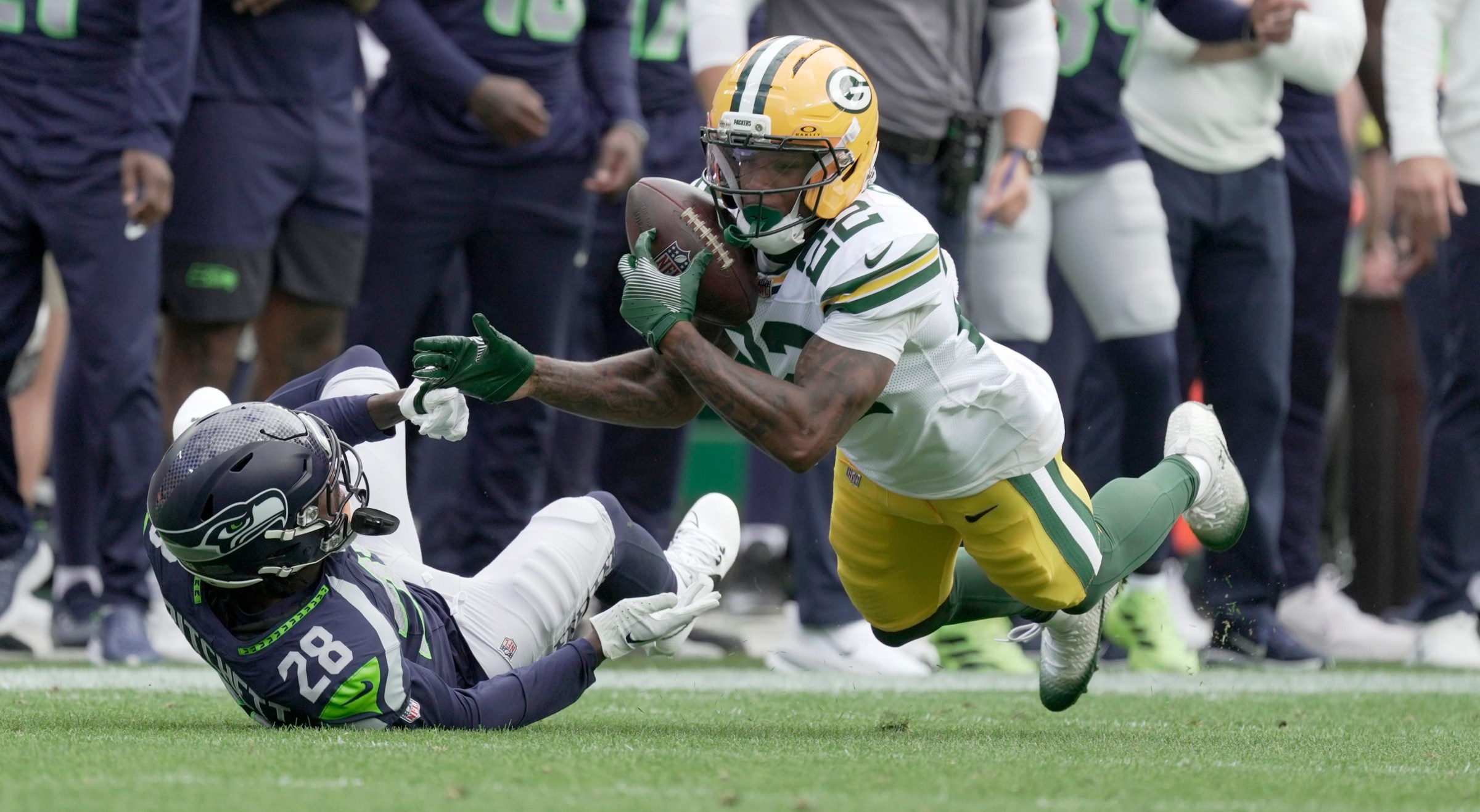 Green Bay Packers wide receiver Matthew Golden (22) makes a 39-yard reception while being covered by Seattle Seahawks cornerback Nehemiah Pritchett (28) during the first quarter of their preseason game Saturday, August 23, 2025 at Lambeau Field in Green Bay, Wisconsin.