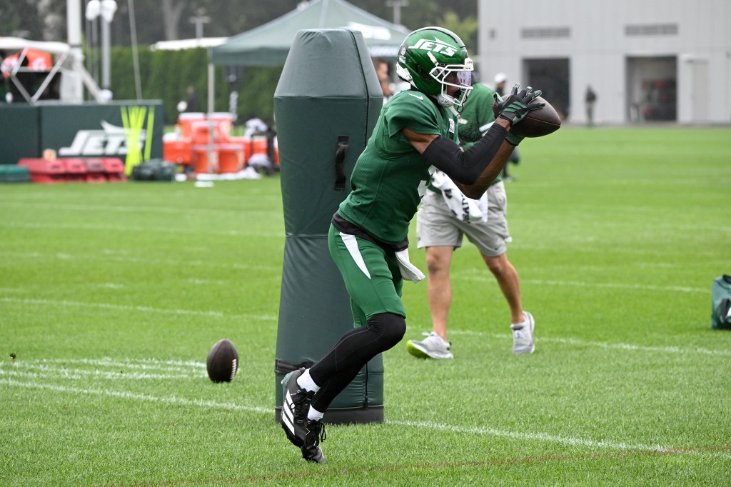 Jets wide receiver making a catch during practice.