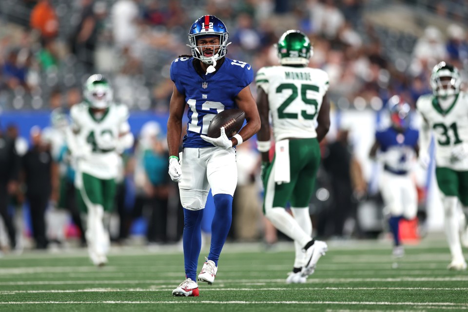 Jordan Bly #12 of the New York Giants carrying the football.