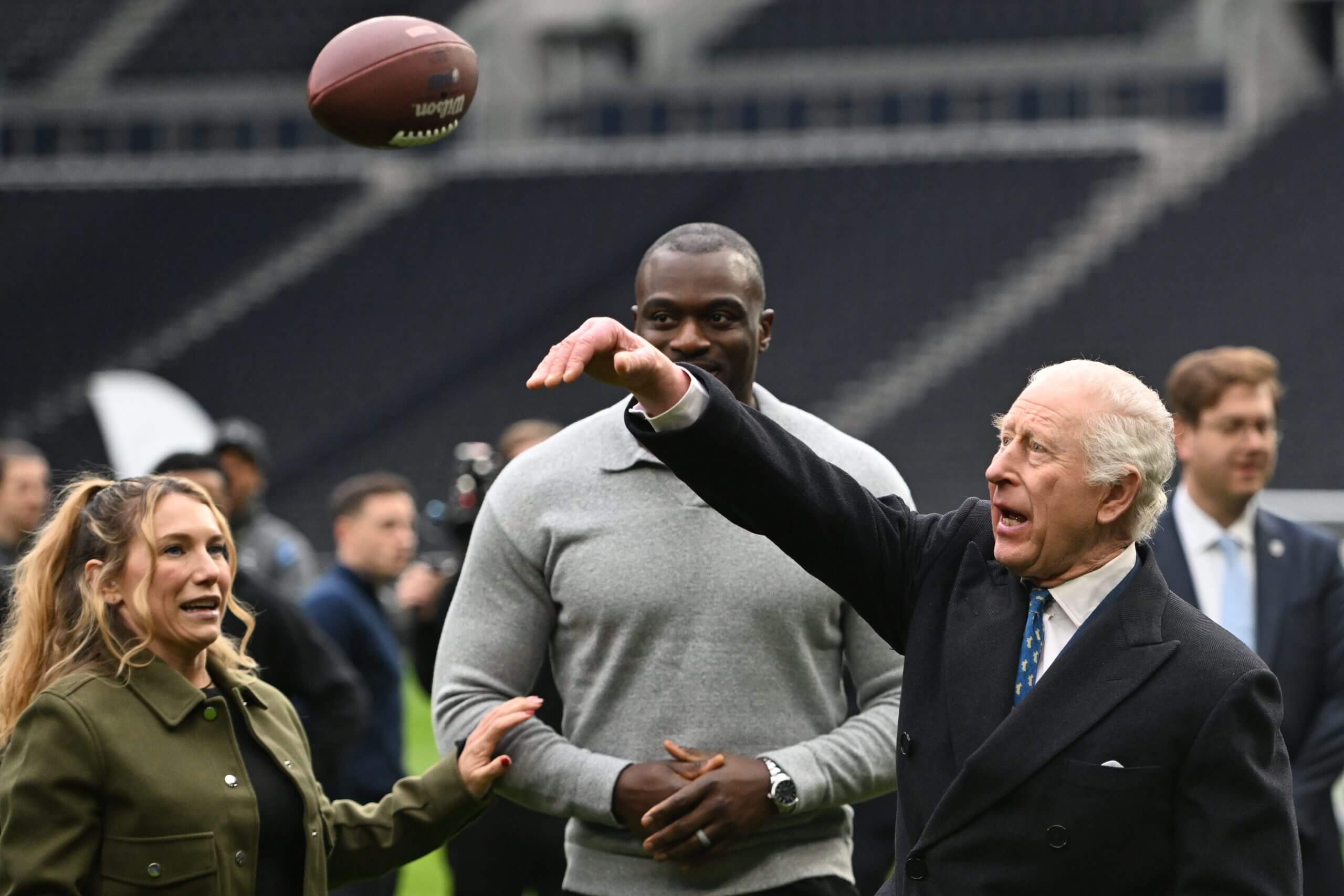 King Charles III with Phoebe Schecter and Efe Obada at a charity event at Tottenham Hotspur Stadium in February (Eddie Mulholland - WPA Pool/Getty Images)