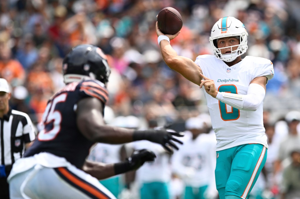 Zach Wilson, Miami Dolphins quarterback, throwing a football.