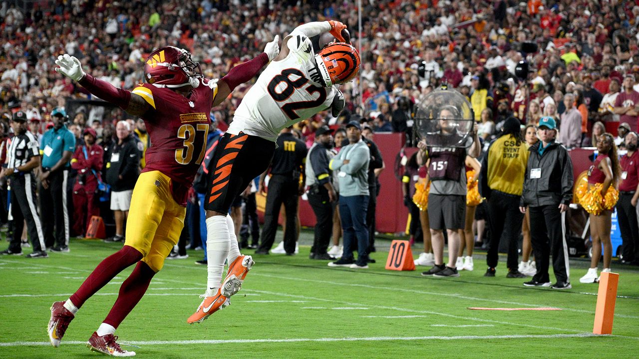 Cincinnati Bengals wide receiver Mitchell Tinsley (82) catches a touchdown pass as Washington Commanders cornerback Bobby Price (37) defends during the first half of a preseason NFL football game Monday, Aug. 18, 2025, in Landover, Md. (AP Photo/Nick Wass)