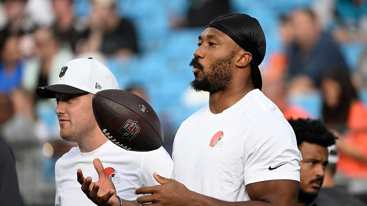 Myles Garrett tosses football on field