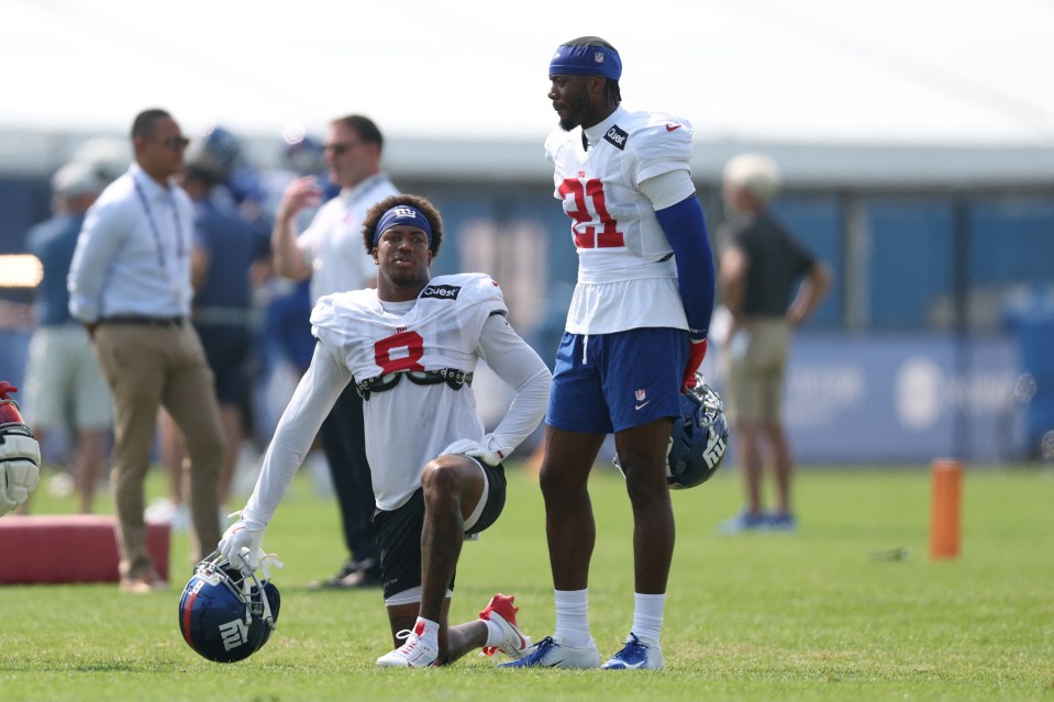 New York Giants players Jevon Holland and Paulson Adebo at training camp.
