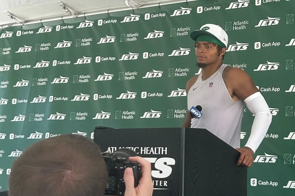 An image collage containing 1 images, Image 1 shows New York Jets player at a press conference